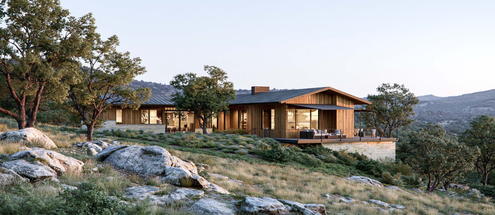 Illustrative wood-sided hillside home with a broad deck overlooking wooded Hill Country ridges.